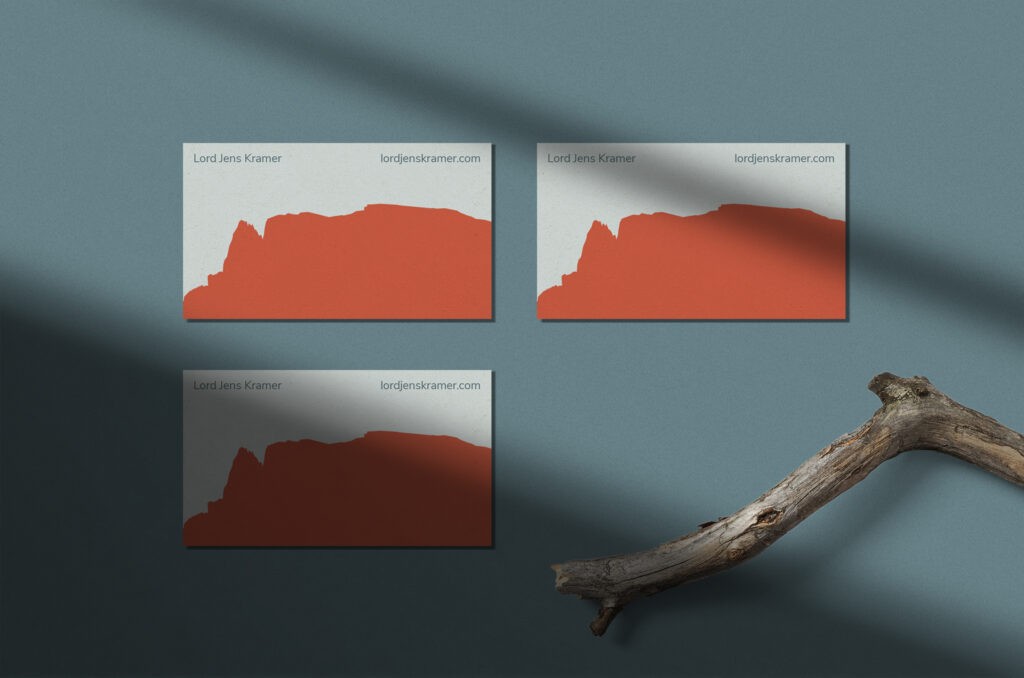 Three business cards for Lord Jens Kramer, each featuring the distinctive silhouette of the Schlern Mountain. The cards are arranged on a teal-grey background.