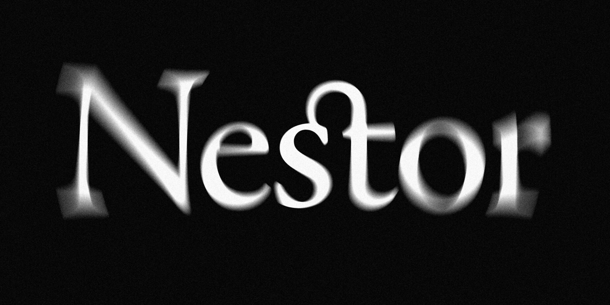The image shows a logo for an imaginary company called 'Nestor', white on black. It uses radial blur as a metaphor for vector vs raster file formats, as its sharp in the middle and blurred on the edges, somewhat like a raster file. Its introducing the article 'Logo File Formats: Everything You Need to Know.'