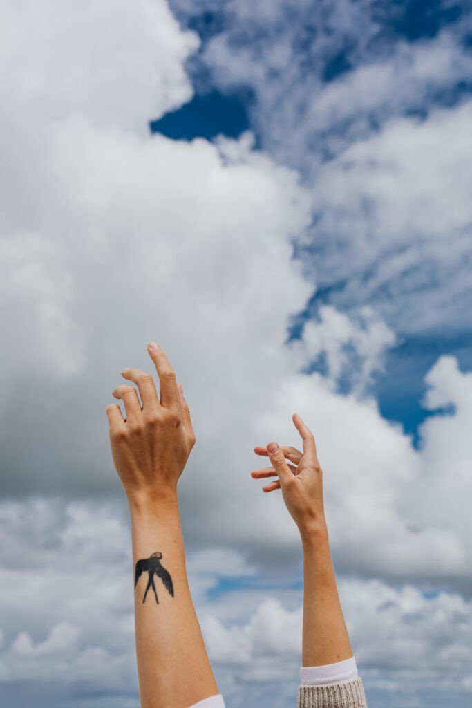 Image shows hands in front of the sky that evoke a certain vibe as a metaphor for brand culture