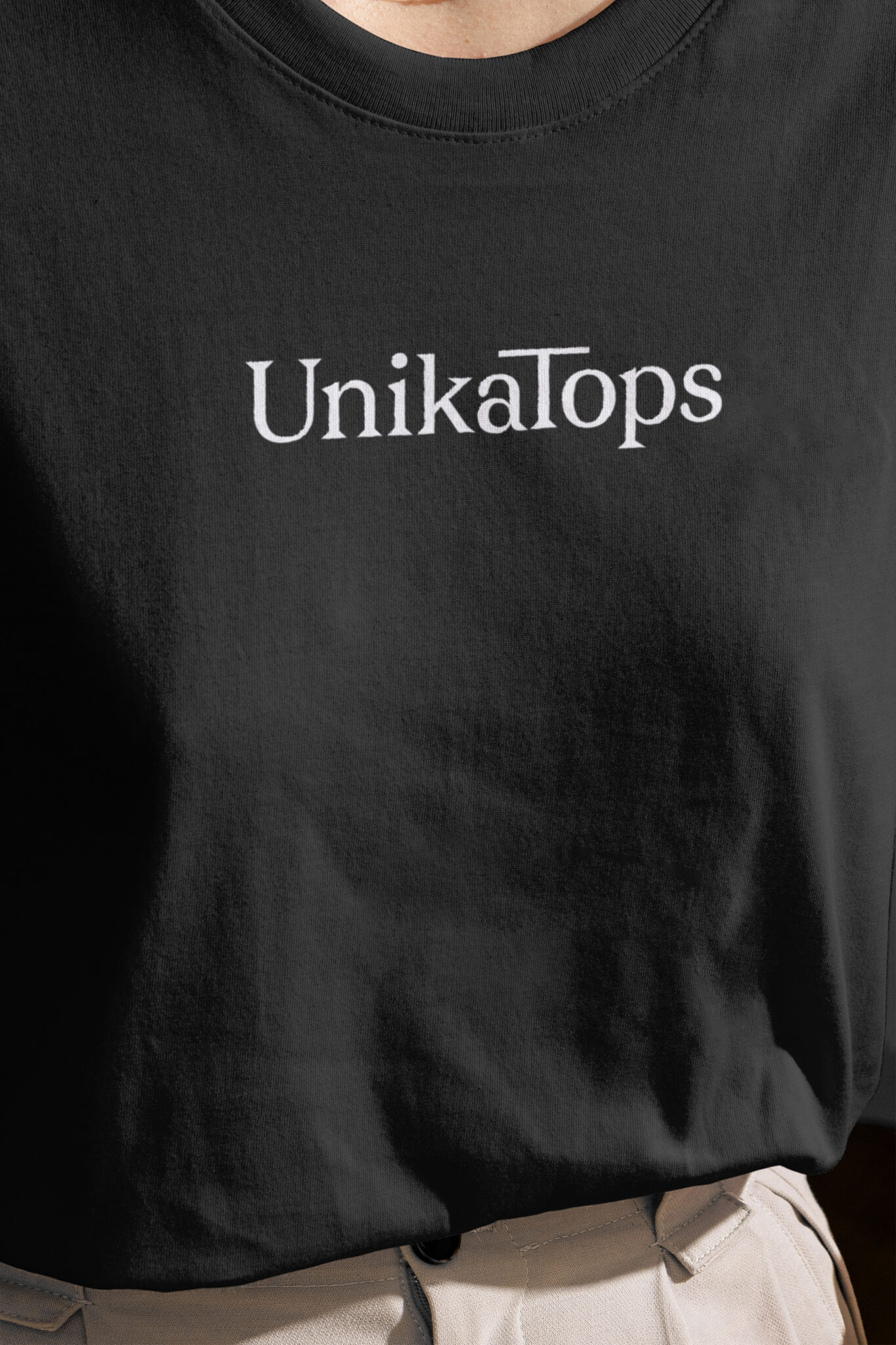 Unikatops Logo mocked up on a black Tshirt
