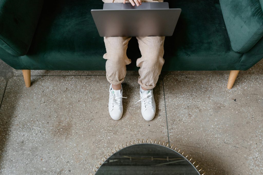 Someone sitting with a laptop on their lap as an introduction to the article "How to Create a Branded Website for Your Business"