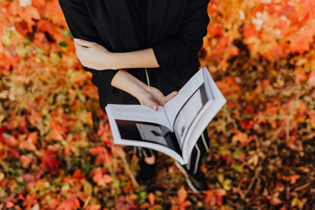 Woman holding a book. This is the intro for my article "How to Create Useful Brand Guidelines for Your Business"