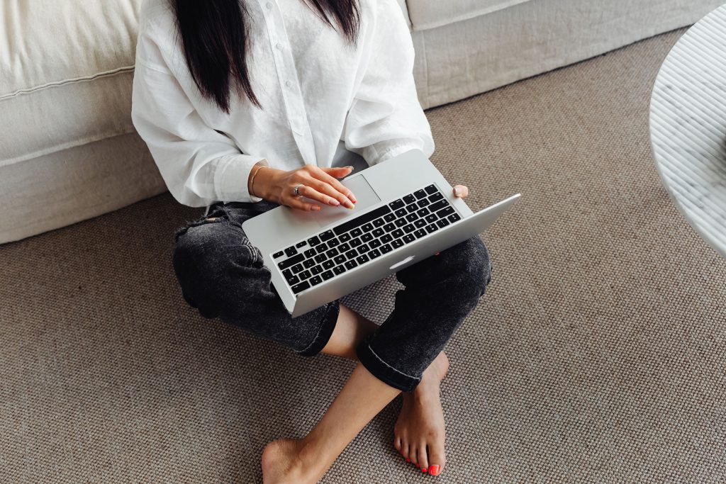 Woman working on her laptop as an introduction to a comprehensive article on brand strategy