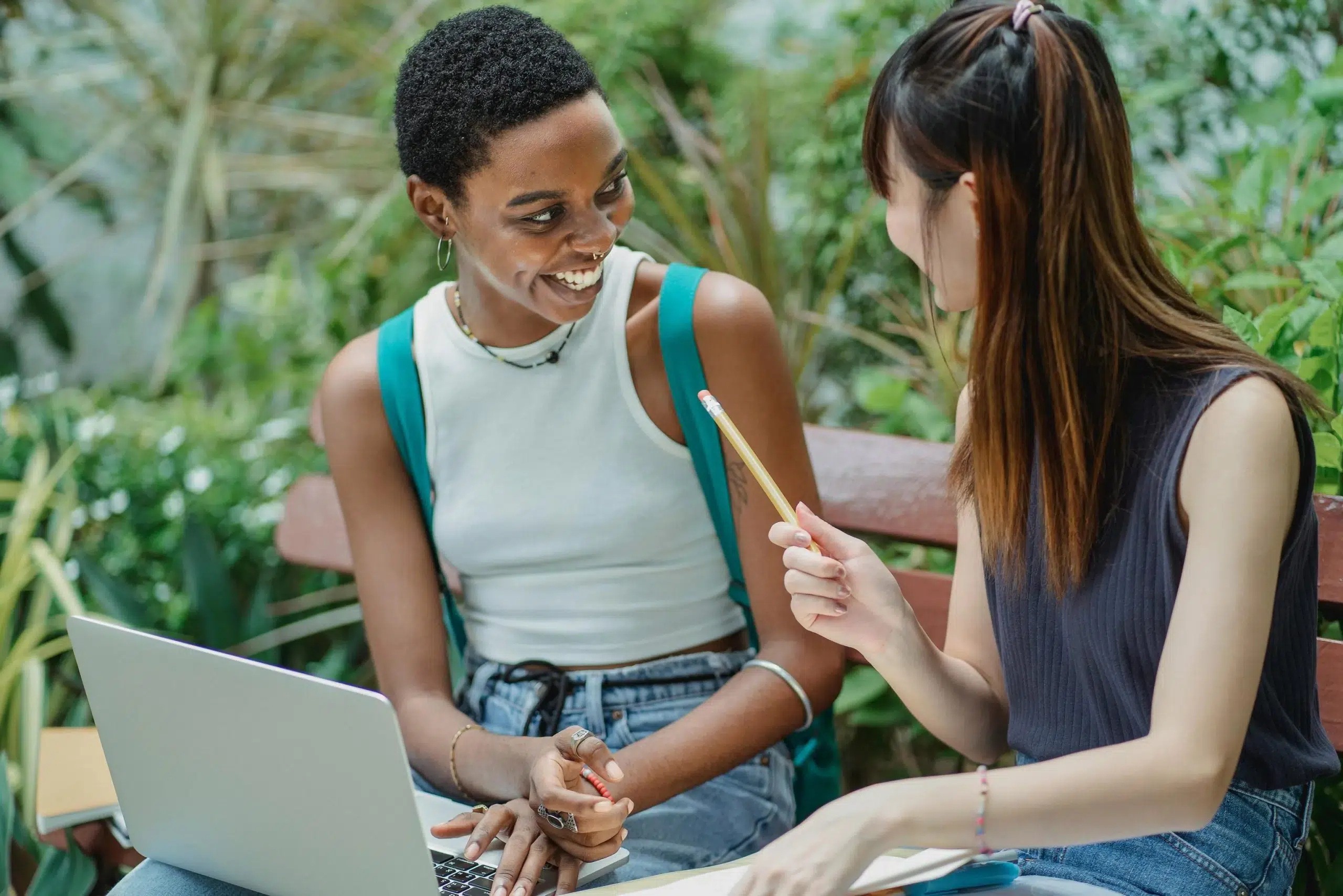 Zwei Frauen beim Brainstorming, lachend. Dieses Bild dient als Einleitung zu meinem Artikel „Wie man in 7 Schritten einen starken Markennamen erstellt“.