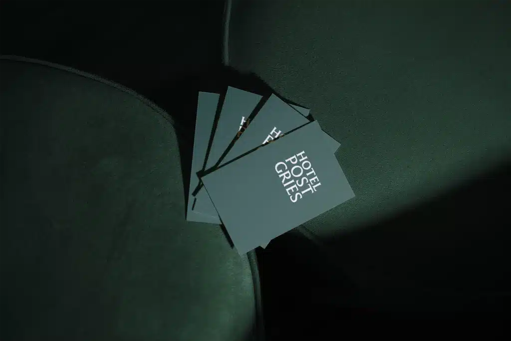 Hotel brand identity for Hotel Post Gries — business card mockup with white print on green board, Bolzano.