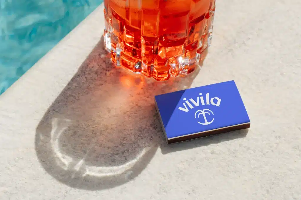 Beverage brand identity for Vivila — poolside drink showcasing the Vivila brand in a hospitality setting.