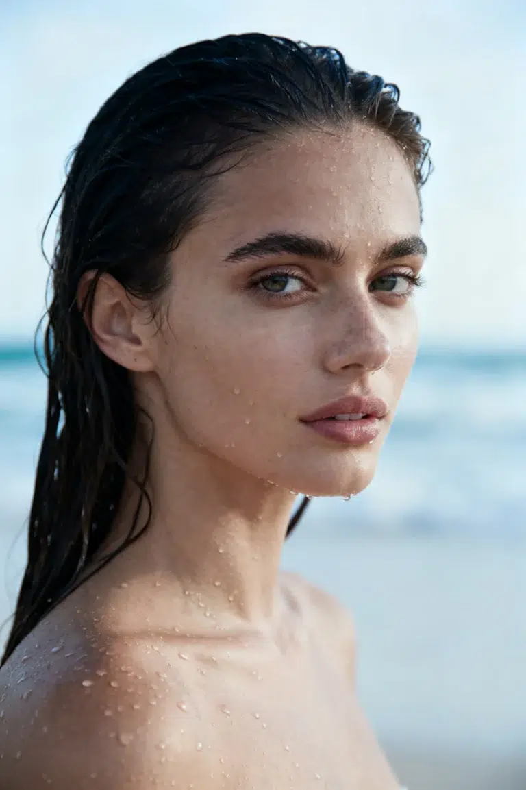 Close up portrait of a woman standing by the sea—an example of a stock image created by AI