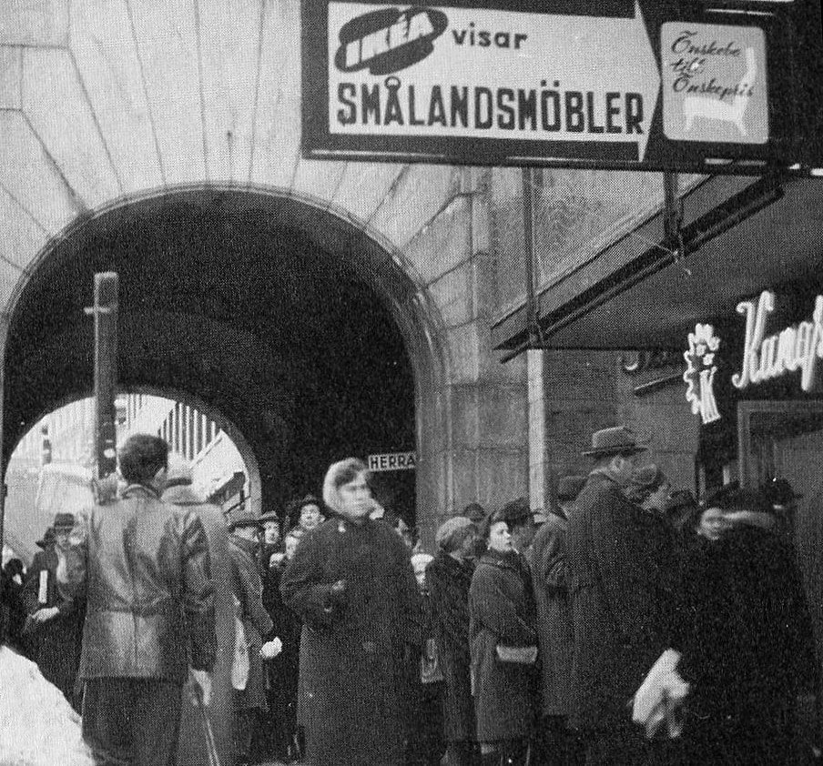 Black-and-white photograph of an IKEA store on Kungsgatan in Sweden from the 1950s. It shows people queuing up, potentially for an opening.