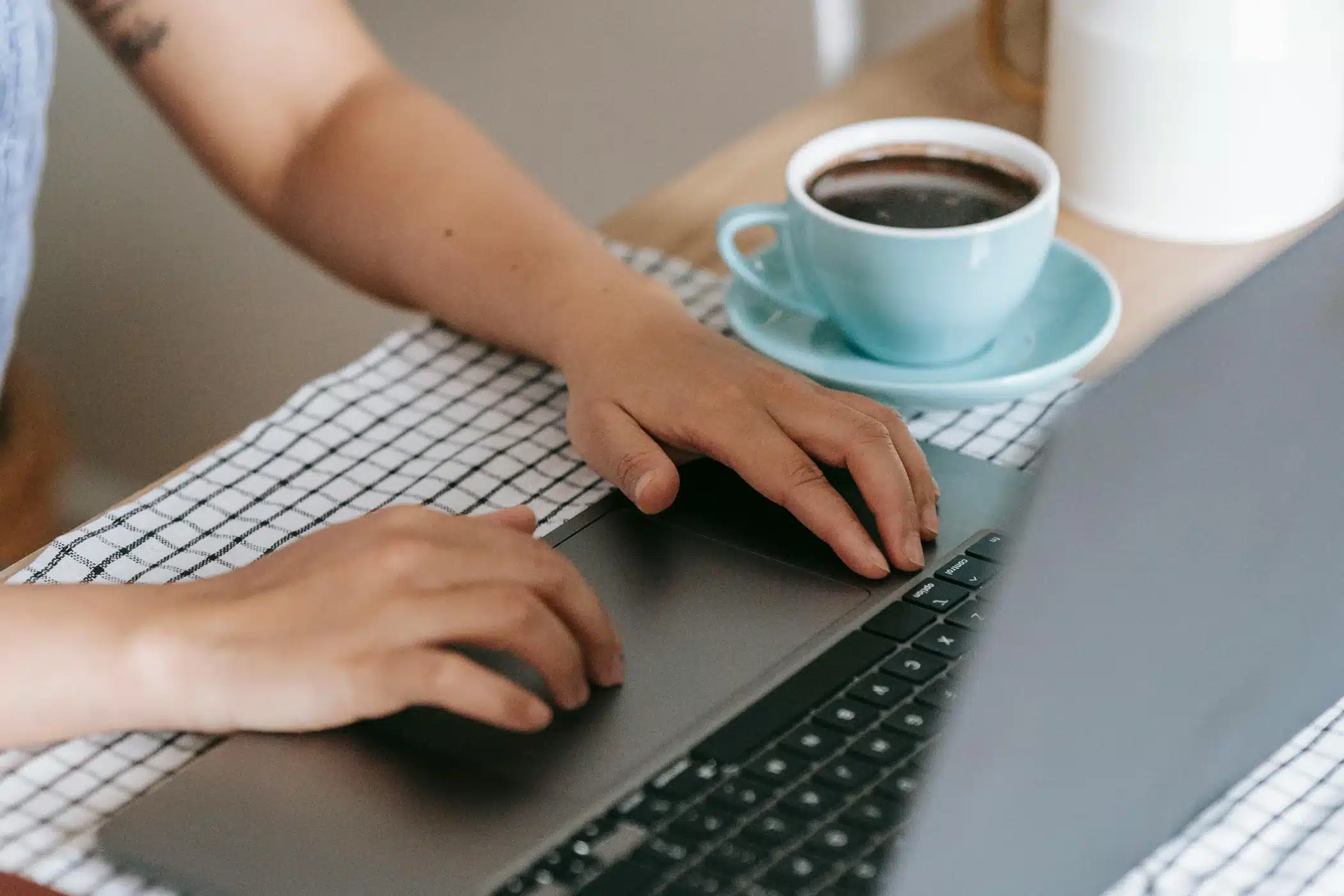 Website copy or design first—person working on a laptop planning their website project