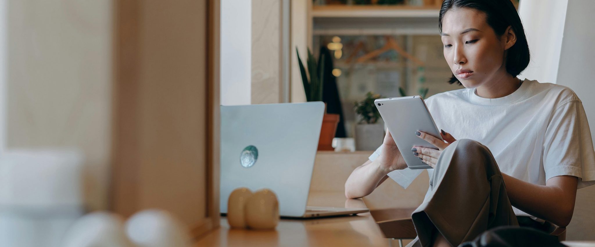 Image of a woman holding an Ipad. This is the introduction to my article "How to Leverage the Halo Effect in Branding and Marketing"