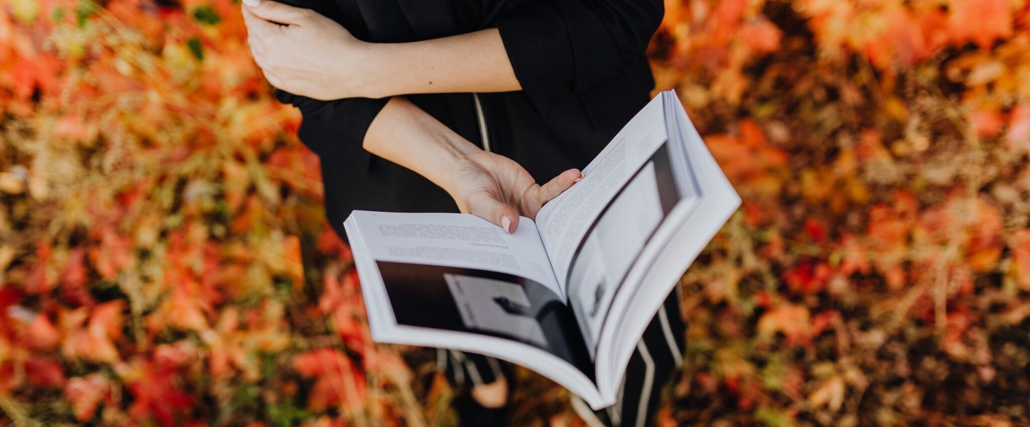 Woman holding a book. This is the intro for my article "How to Create Useful Brand Guidelines for Your Business"