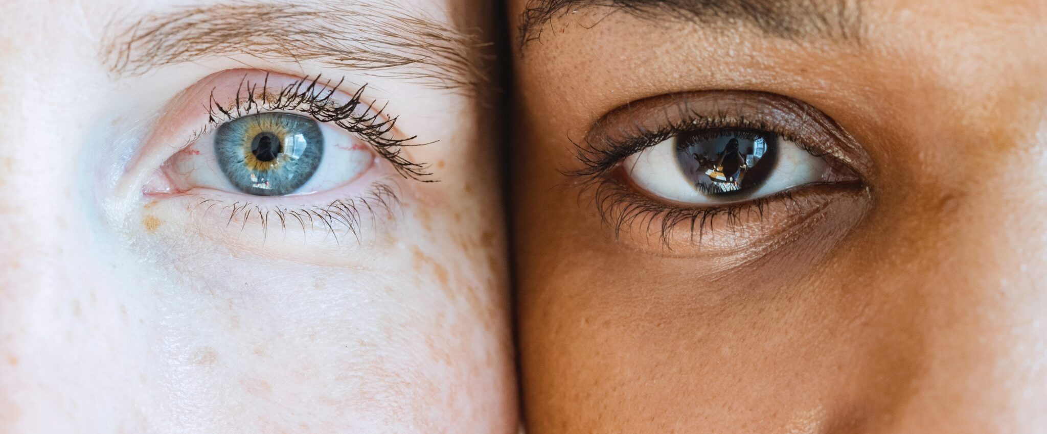 The picture shows a detail of two faces with different colours and skin tones as a metaphor for different brand personalities.